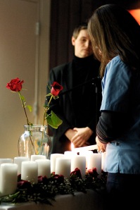 Guider Holly lighting a candle during the candlelight procession